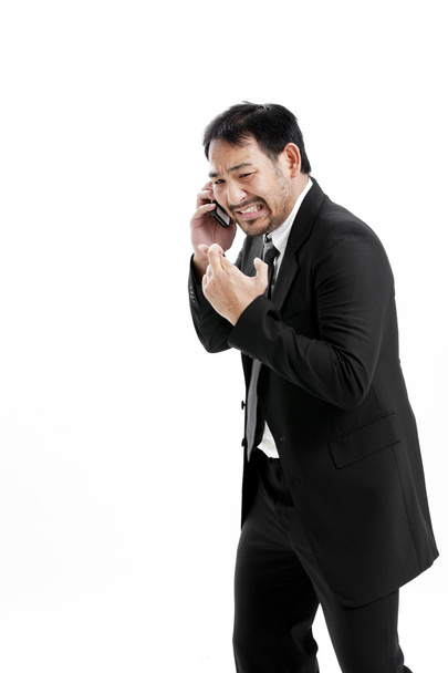 Superstitious - Asian business man with crossed fingers over white background - Photo, image