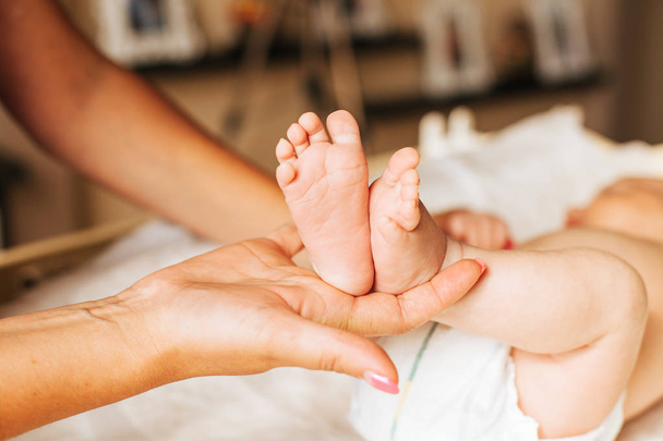 doctor massaging small baby's foot - Фото, изображение
