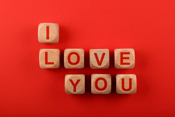 Wooden cubes with I LOVE YOU words over red - Foto, Imagem