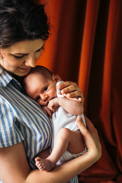 young woman holding her infant child  - Valokuva, kuva