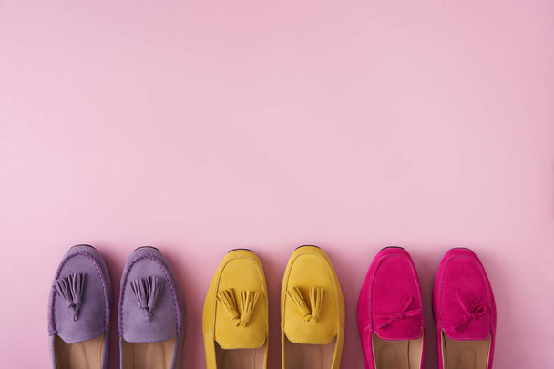 Multicolored suede moccasins shoes over pink background - 写真・画像