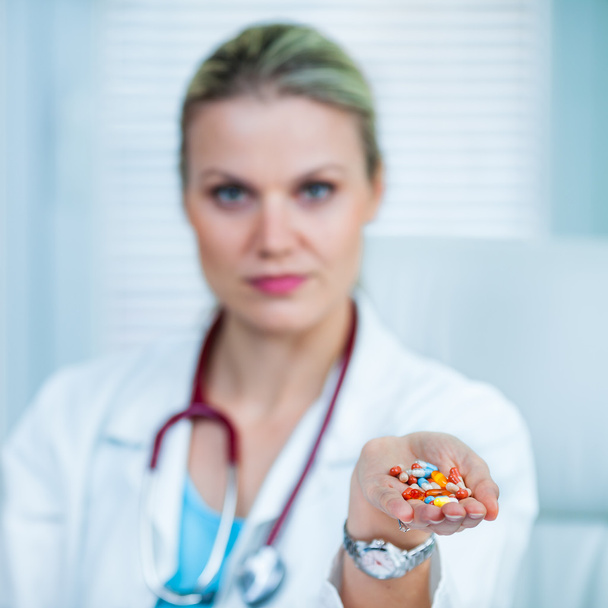 Pretty Young Female Doctor Is Showing a Handful of Medication / - Photo, Image