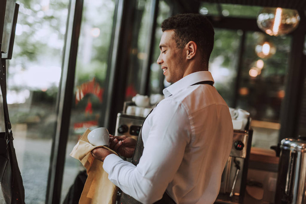 Handsome bartender wiping cup with cleaning cloth - Φωτογραφία, εικόνα