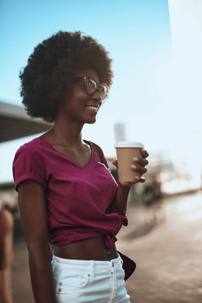 Smiling afro-american woman enjoying coffee on the street - Φωτογραφία, εικόνα