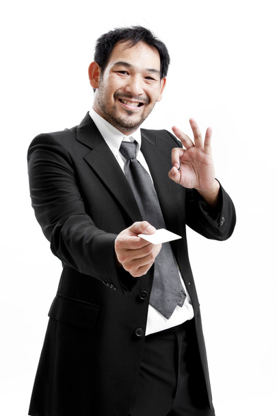 Business man handing a blank business card over white background - Foto, Imagem