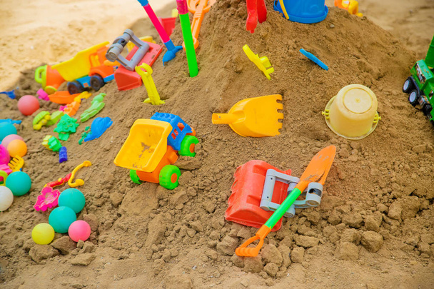 lot of children's toys in the sandbox. Selective focus. - Фото, изображение