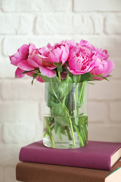 Vase with beautiful peony flowers and books on white background - Fotografie, Obrázek
