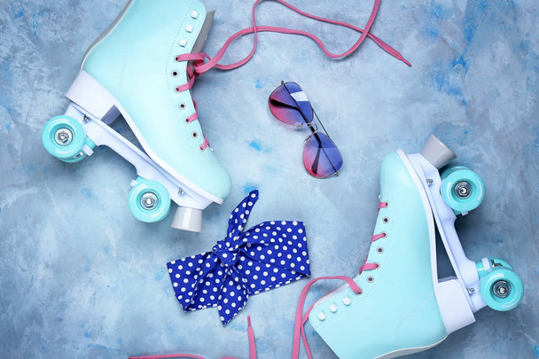 Vintage roller skates and accessories on color background - Фото, изображение