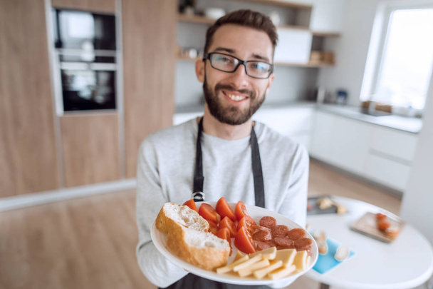 plate of sandwiches in the hands of an attractive man - Fotografie, Obrázek
