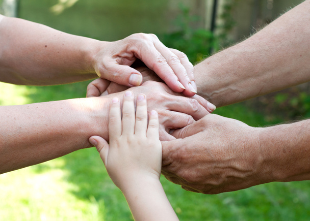 Family holding hands together outdoor - Photo, Image