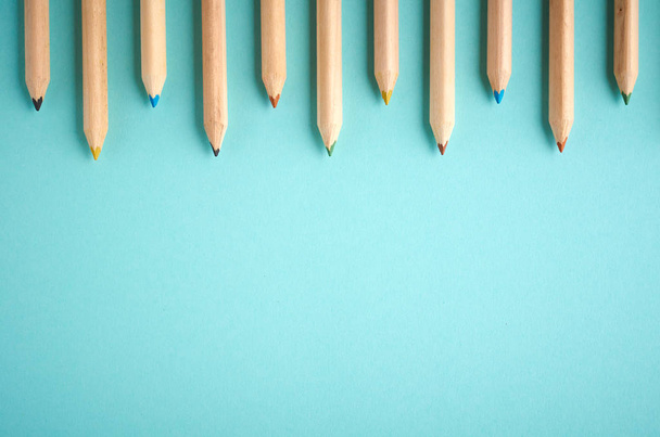 Wooden color pencils on blue background, flat lay - Fotografie, Obrázek