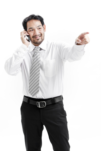 Portrait of a happy young businessman talking on mobile phone - Fotó, kép