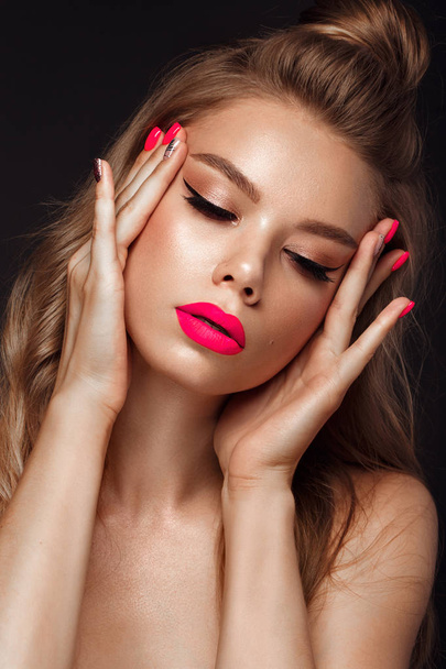 Beautiful young woman with bright makeup and neon pink nails. Beauty face. Photo taken in the studio - Photo, image