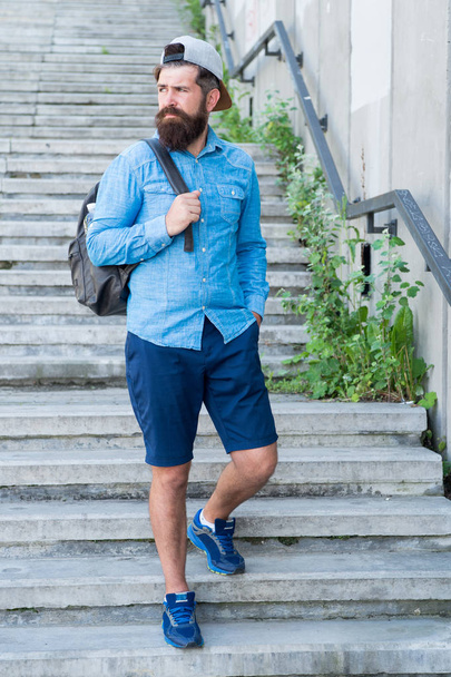 Kick your feet up and go. hiking adventure concept. urban style. Mature hipster with beard traveller. Bearded man. Confident brutal man walk street. Male barber care. hipster with travel backpack - Zdjęcie, obraz