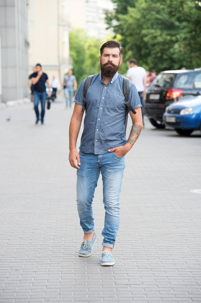 Confident brutal man walk street. Male barber care. brutal hipster with moustache. adventure concept. urban style. Commit to travel. Mature hipster with beard. Bearded man wear backpack - Foto, afbeelding