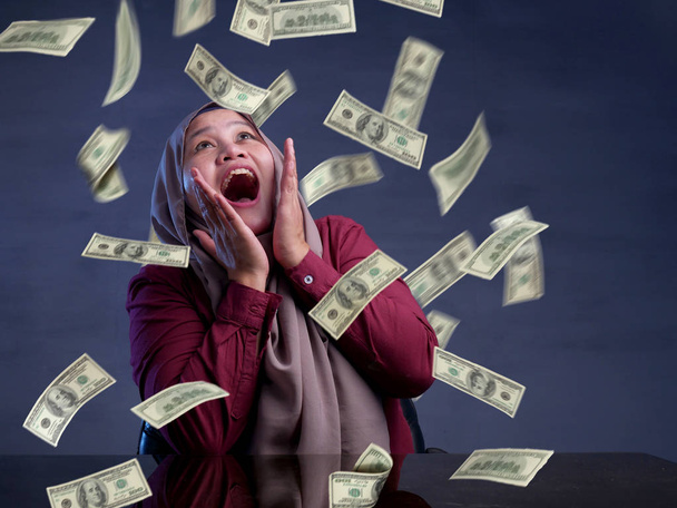 Young Woman Under Rain of Money - Foto, afbeelding
