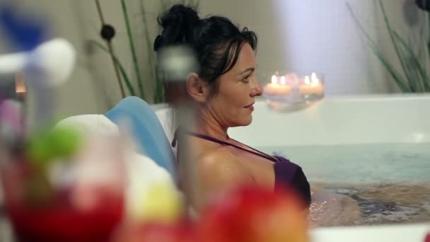 Shot of an older woman soaking in jacuzzi in a fancy hotel - Footage, Video