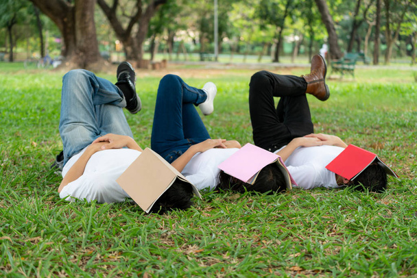 Funny students sleeping with books on their face. - Foto, imagen