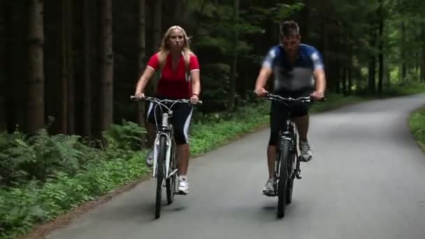 totaal van jonge paar fietsen in bos - Video