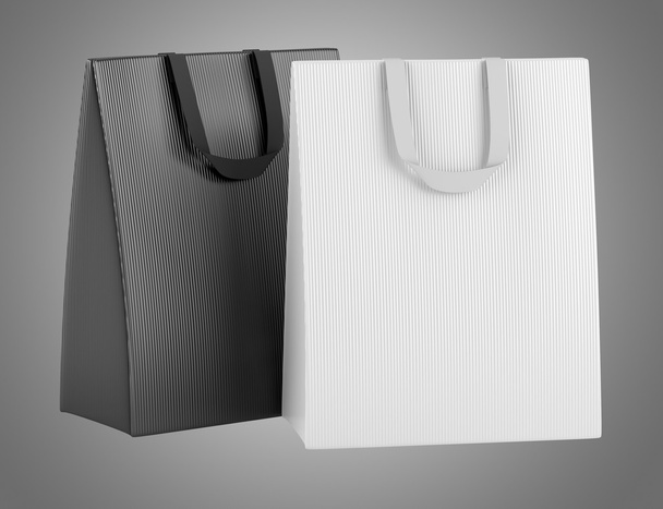 dos bolsas de compras en blanco aisladas sobre fondo gris
 - Foto, Imagen