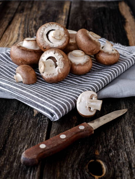 Brown mushrooms on old dark wooden background - Foto, Imagem