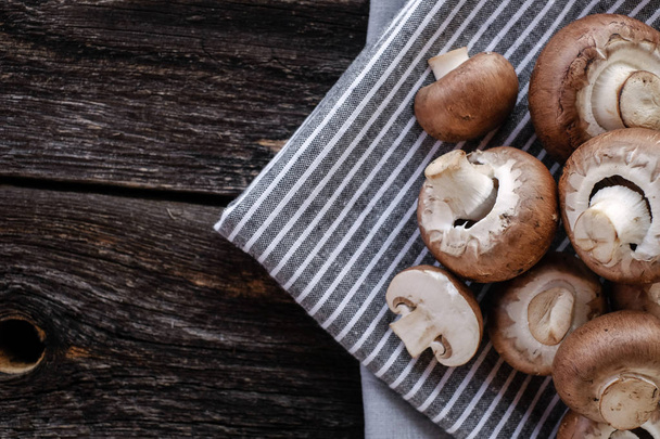 Brown mushrooms on old dark wooden background - Zdjęcie, obraz