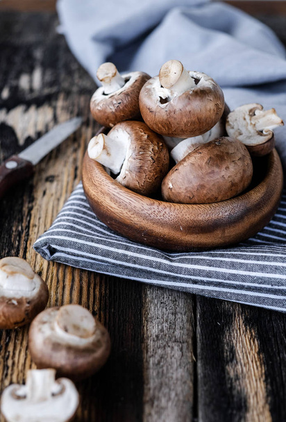 Brown mushrooms on old dark wooden background - Fotoğraf, Görsel