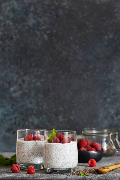 Chia pudding with yogurt and raspberries in a glass  - Фото, изображение