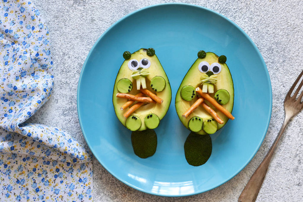 Lunch for the child. Funny beavers from avocado in a plate  - Photo, Image
