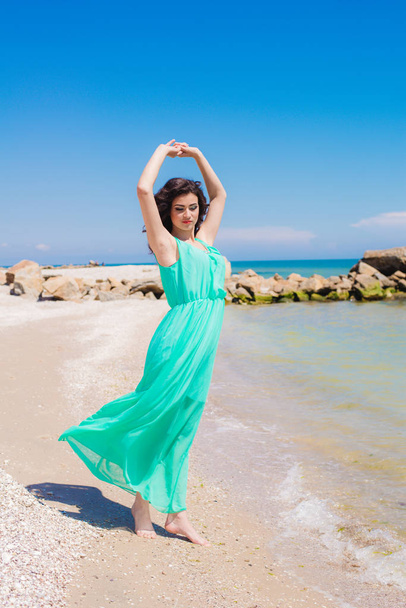 Young girl on summer beach with shell  - Фото, зображення