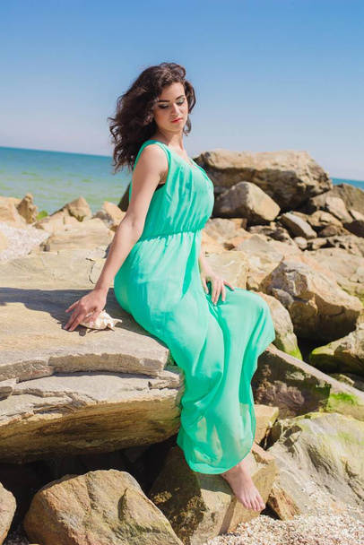 Young beautiful girl in a long dress on the beach  - Fotografie, Obrázek
