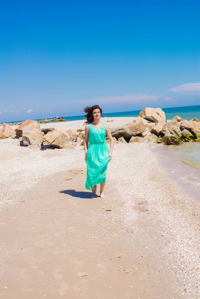 Young beautiful girl in a long dress on the beach  - Foto, immagini