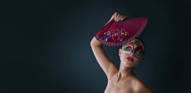 Woman wearing venetian masquerade carnival mask  - Fotó, kép
