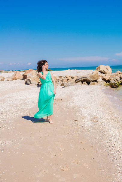 Young beautiful girl in a long dress on the beach  - Foto, Imagem