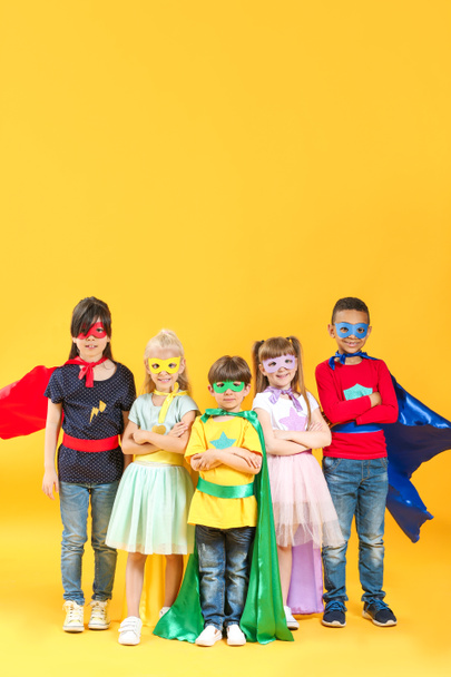 Cute little children dressed as superheroes on color background - Photo, Image