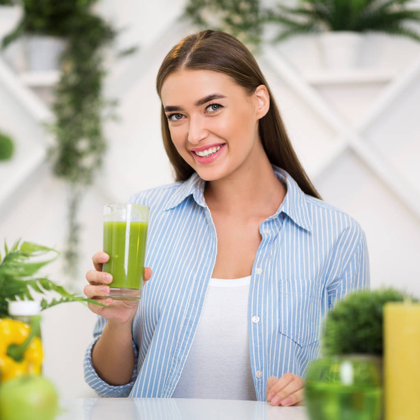 Happy woman holding glass of healthy smoothie - Photo, Image