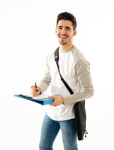 Portrait of Handsome college student man with backpack and notepad folder smiling against white background on his way to university lecture. in People fashion and university lifestyle concept. - Photo, Image