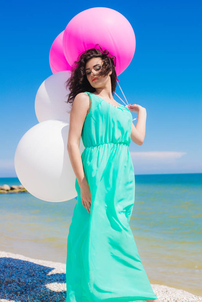Beautiful girl on the beach with colorful balloons  - Фото, зображення