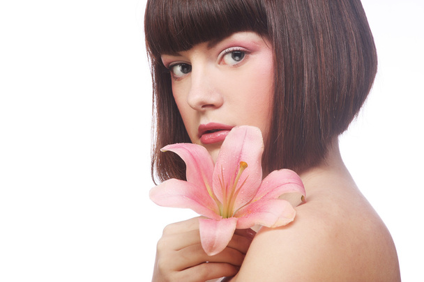 Portrait of beautiful woman with pink lily flower - Fotoğraf, Görsel