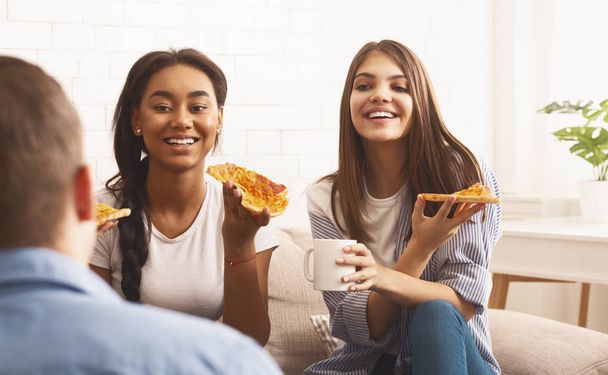 Students eating pizza and talking at home - Photo, Image