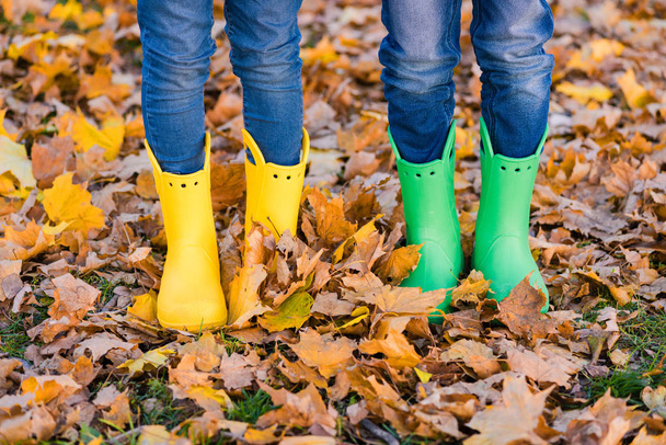 Kids foots in jeans and bright gumboots - Photo, Image