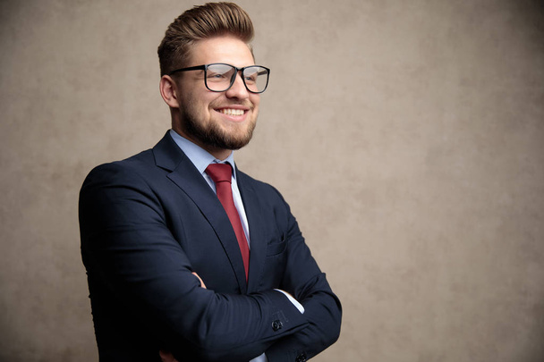Positive businessman smiling with his hand folded  - Fotografie, Obrázek