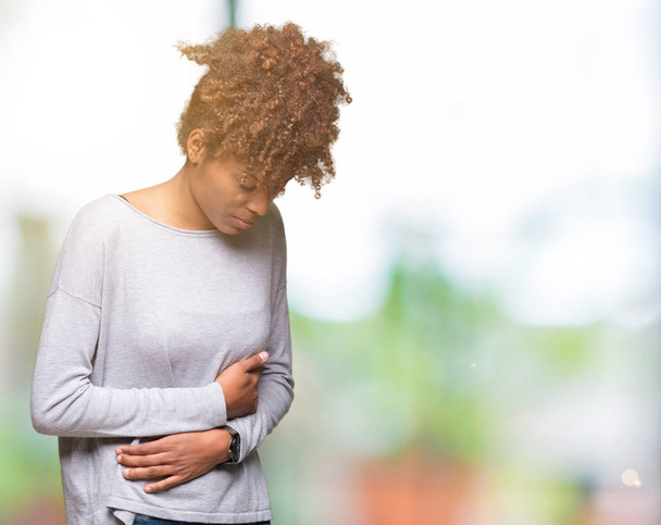 Beautiful young african american woman over isolated background with hand on stomach because nausea, painful disease feeling unwell. Ache concept. - Photo, Image