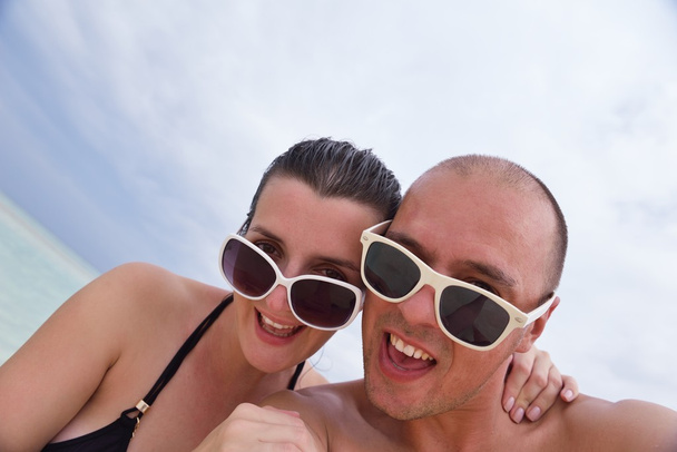happy young couple at summer vacation have fun and relax at bea - 写真・画像