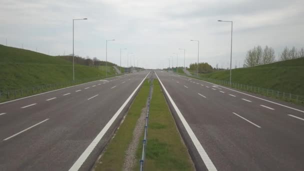 Panorama of the motorway with a bird's eye view. Transport artery of the country. The movement of vehicles on the highway. Landscape design of communication paths. Roadworks and marking. Stream cars. - Footage, Video