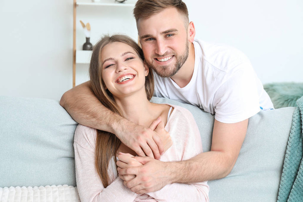 Portrait of happy young couple at home - Foto, Imagem