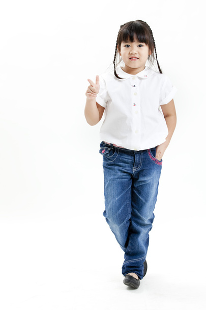 Little girl portrait with white shirt and blue jeans having fun on the white background - Φωτογραφία, εικόνα