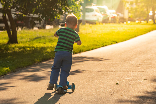 child riding scooter outdoors, active sport kids - Zdjęcie, obraz