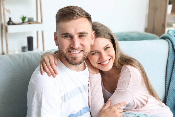 Portrait of happy young couple at home - Foto, imagen