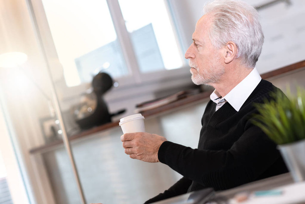 Gondolkodó Senior üzletember néz ki az ablakon - Fotó, kép